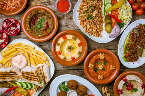 istock assorted Turkish dishes, hummus, muhamara, mutabal, falafel, shawarma 1182985380