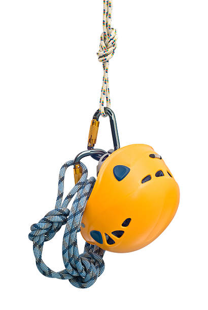 Isolated new climbing equipment - carabiners without scratches, yellow helmet and rope