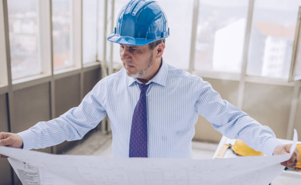 istock Businessman controls the construction of office space 1182985441