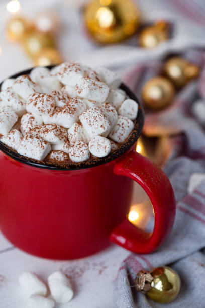 istock Hot chocolate in red cup with marshmallow on white christmas background. 1182986967