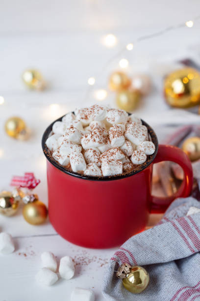 istock Hot chocolate in red cup with marshmallow on white christmas background. 1182986992