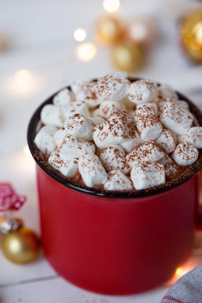istock Hot chocolate in red cup with marshmallow on white christmas background. 1182987513