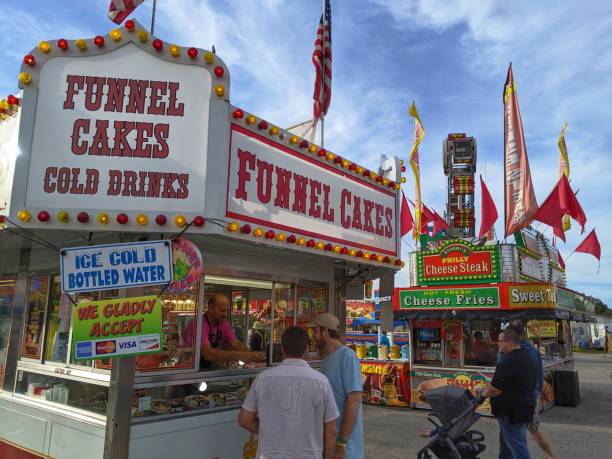 Pensacola Interstate Fair in Florida USA Pensacola, Florida, October 22, 2019 - The Pensacola Interstate Fair is busy with people having fun and purchasing funnel cakes from a food vendor florida food stock pictures, royalty-free photos & images