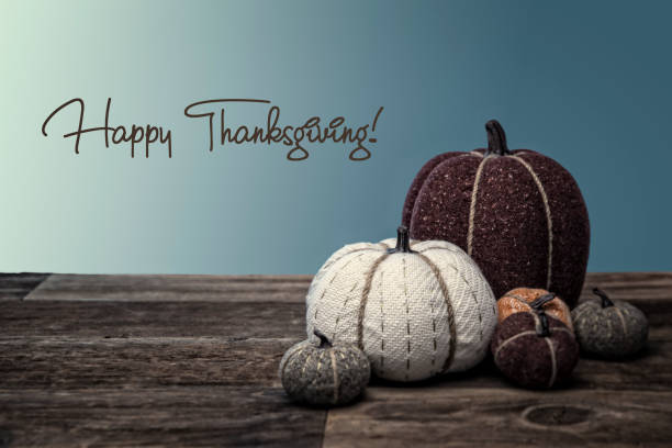 istock Autumn quilted pumpkins on wood background 1182988777