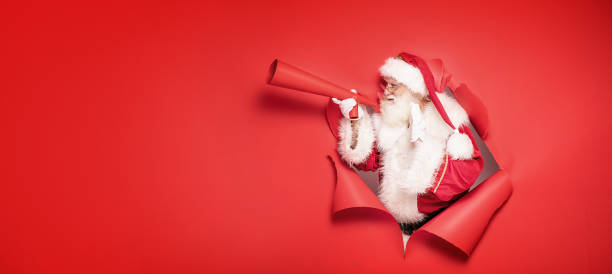 istock Santa Claus screaming by megaphone. 1182993920