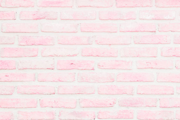 istock Pastel Pink and White brick wall texture background. Brickwork or stonework flooring interior rock old pattern clean concrete grid uneven bricks design stack. 1182994742
