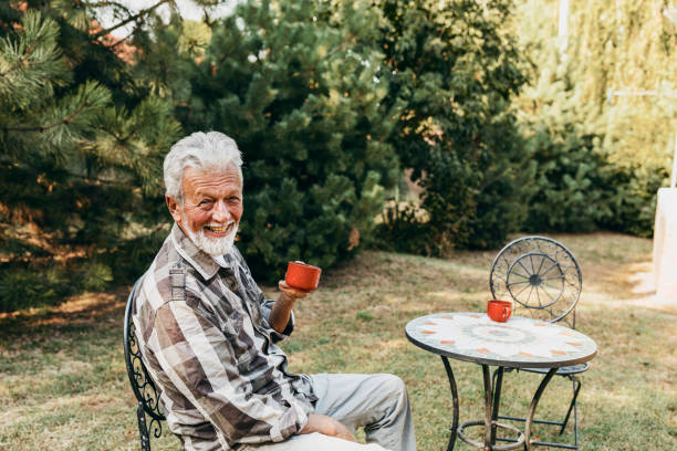 istock Senior Man with Beard Drinking Coffee in his Backyard 1182995081