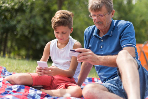 istock Grandfather and his grandson shopping online 1182995116