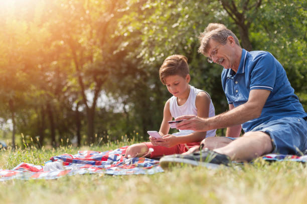 istock Senior man shopping online with his grandson 1182995121