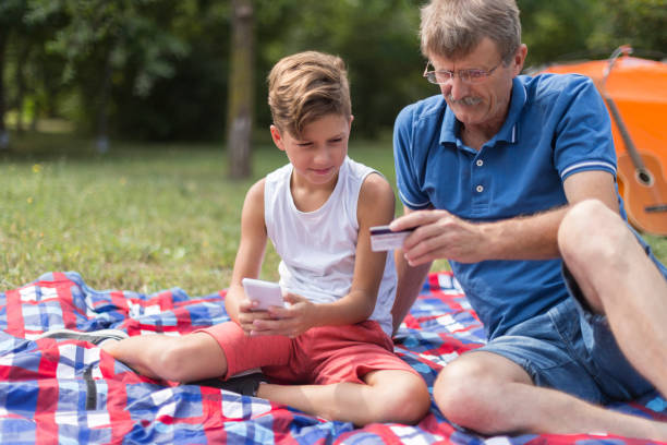 istock Grandpa and grandson buying on the internet 1182995123