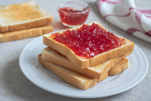 istock Toast bread with strawberry jam on plate 1182995907
