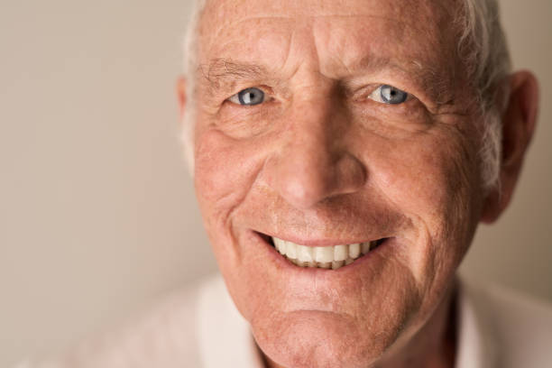 istock Happy senior man smiling while sitting alone at home 1183000777