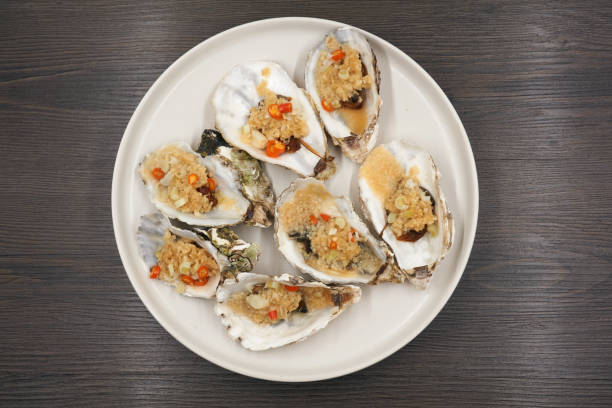 istock Oysters isolated on wood background. 1183001798
