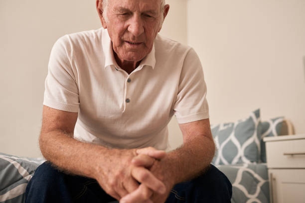 istock Sad senior man sitting on his retirement home bed 1183002053