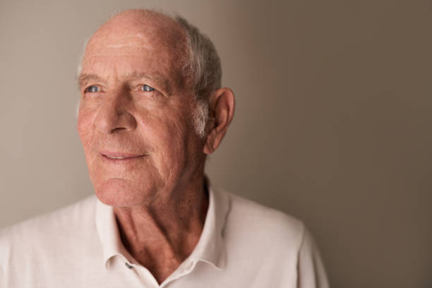 istock Smiling senior man thinking back on his life 1183004365