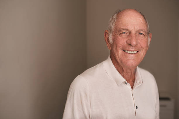istock Smiling senior man relaxing in his retirement home room 1183004445