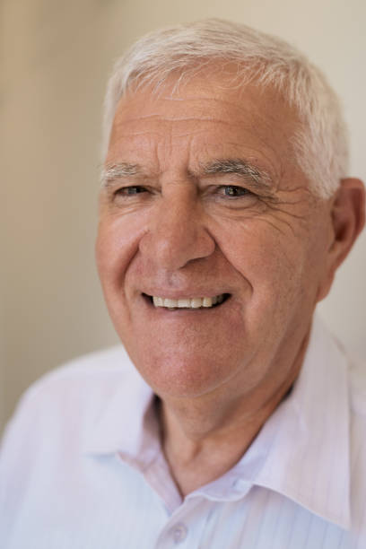 istock Senior man smiling while relaxing at home 1183007203