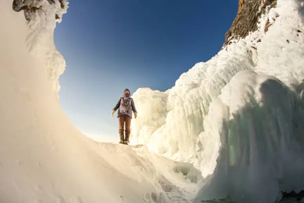 Photo of The girl on the background of the ice wall. Baikal, Russia