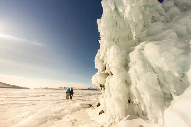 Photo of The girl on the background of the ice wall. Baikal, Russia