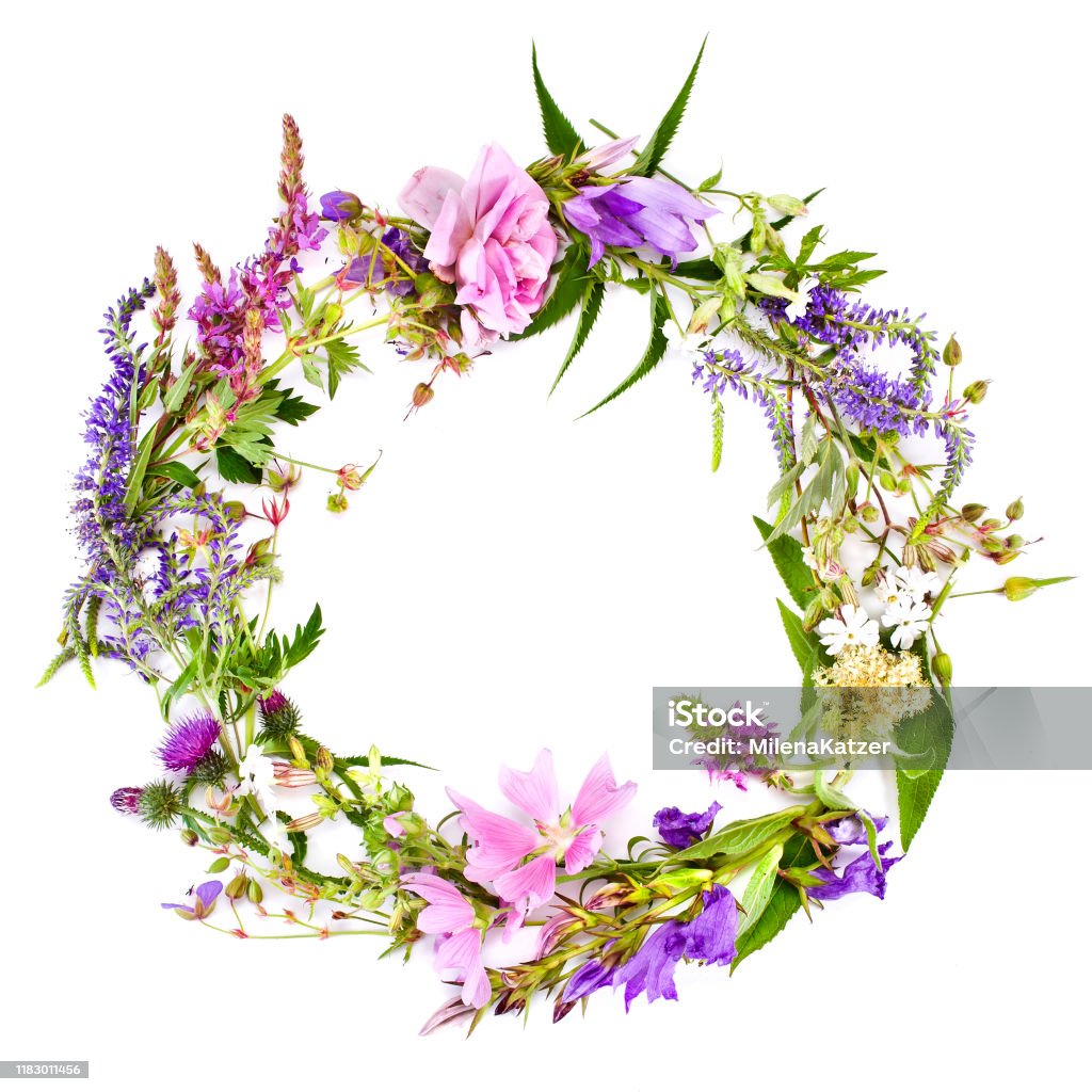 Beautiful flower wreath with colorful blooming flowers. Beautiful flower wreath with colorful blooming flowers isolated on a white background. Midsummer celebration concept, summer decoration. Wreath Stock Photo