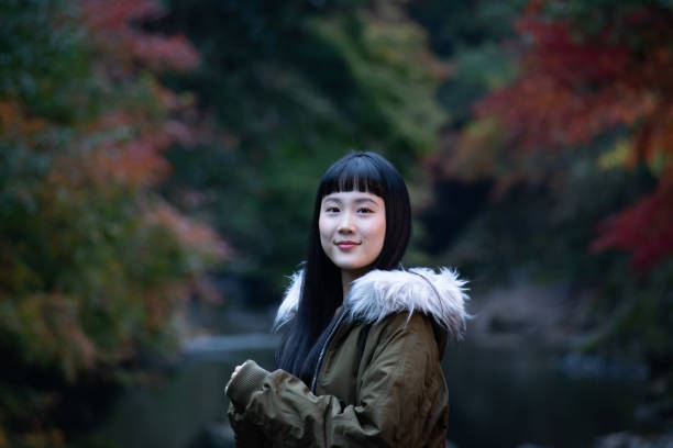 istock Girl with autumn leaves 1183011667