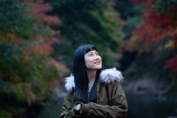 istock Girl with autumn leaves 1183016691
