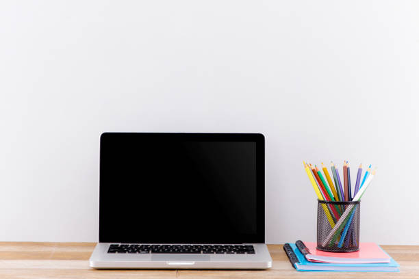 istock Mock up laptop, notebook on young student desk. Cyan pastel colors. 1183024382