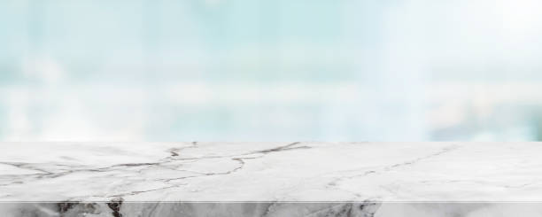 istock Empty white marble stone table top and blur glass window wall building banner mock up abstract background - can used for display or montage your products. 1183030237
