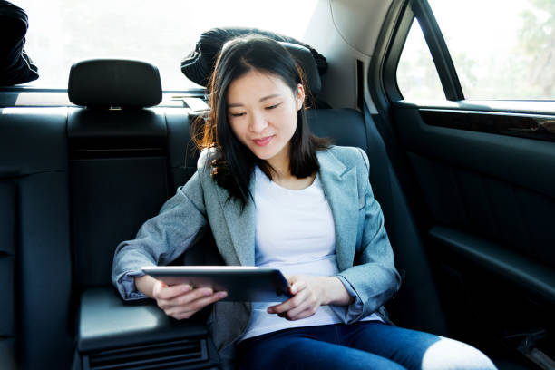 istock Businesswoman using digital tablet in car 1183031555
