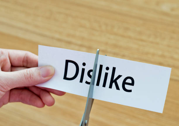 istock Human hand cutting the dislike word 1183031586