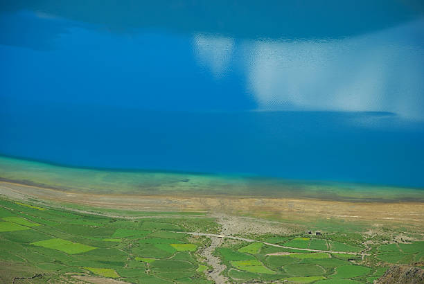 Turqoise blue lake and fields stock photo