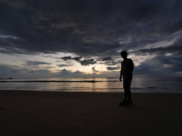 istock Silhouette​ Man​ on the Beach​ sunset 1183035071