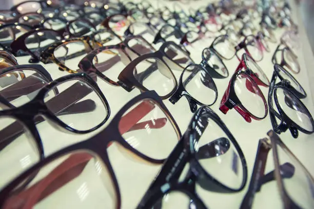 Photo of Row of glasses at an opticians. Eyeglasses shop.
