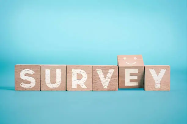 Photo of Survey Concept With A Smiley Face On The Blue Background