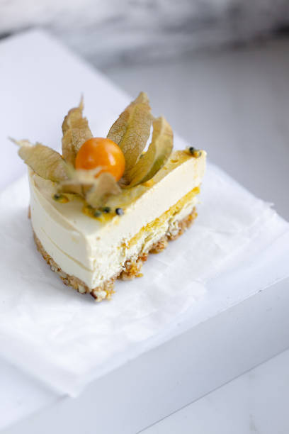 istock Passionfruit vegan cheesecake with Physalis on marble background with copy space 1183037442