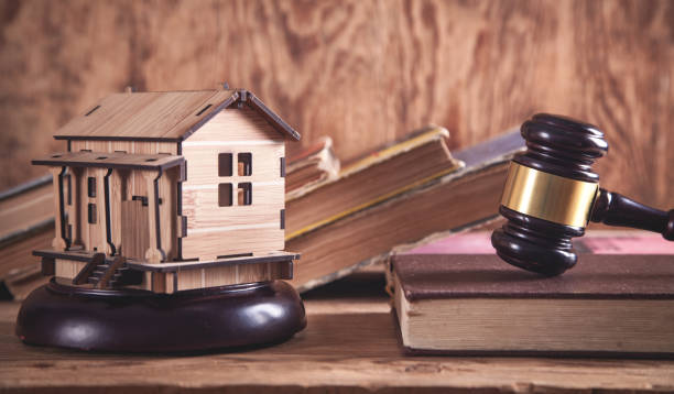 istock Judge gavel with a wooden house model. 1183038682