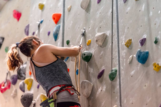istock Woman climbing on climbing wall 1183038768