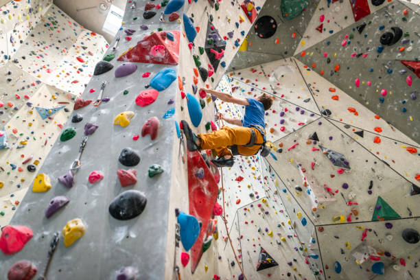 istock Man climbing on climbing wall 1183038769