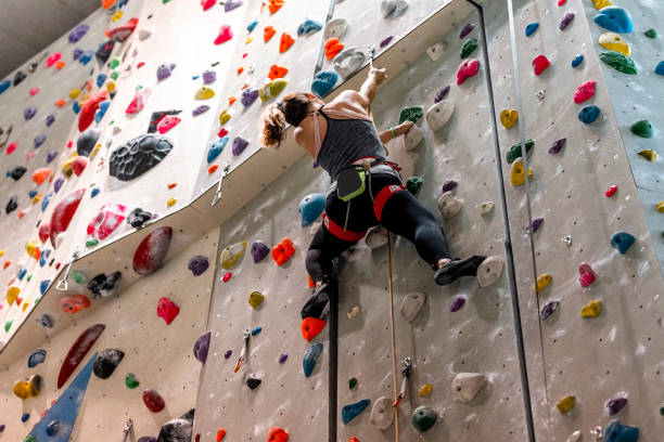 istock Woman climbing on climbing wall 1183038770