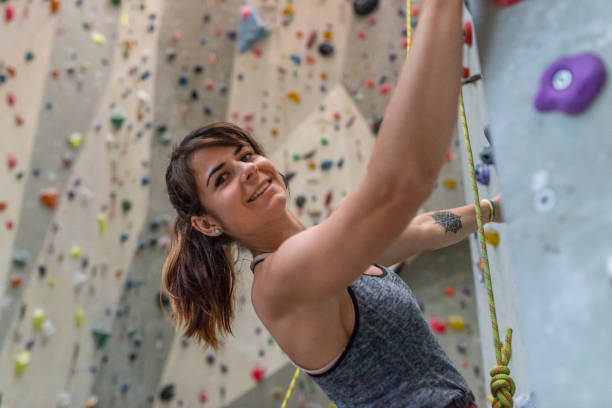 istock Woman climbing on climbing wall 1183038776