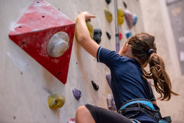 istock Girl climbing on climbing wall 1183038777