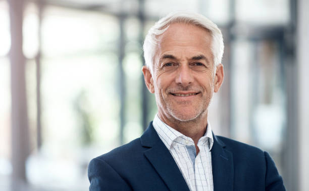 Confidence and success go hand in hand Portrait of a confident mature businessman working in a modern office white hair photos stock pictures, royalty-free photos & images