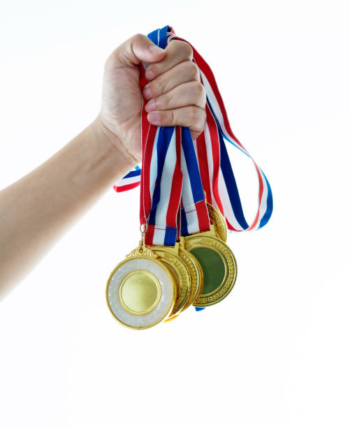 istock Human hand holding gold medals 1183039129