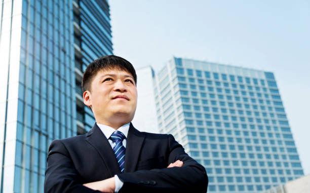 istock Businessman standing in front of office building 1183039939