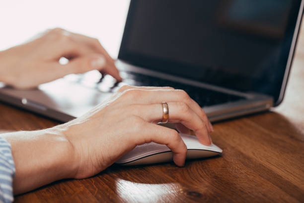 istock Woman using laptop on light table, closeup 1183040260