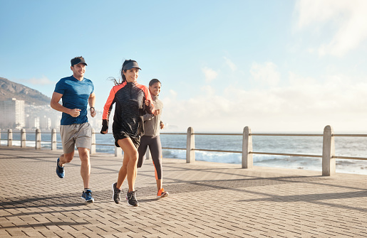 Shot of a small group of three people out for a run together on the promenade