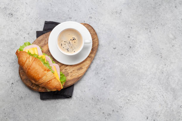 istock Coffee and croissant sandwich 1183043460