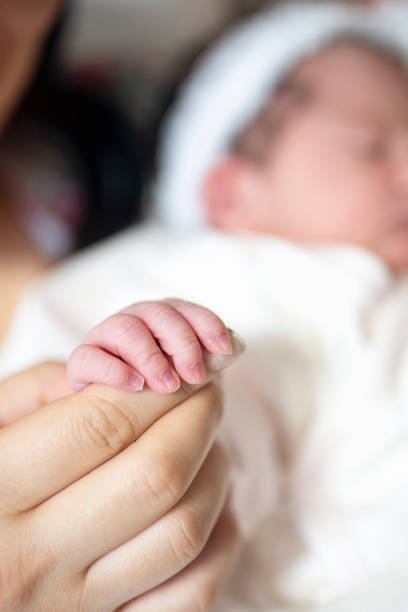 istock Baby Holding Mothers Hand 1183044659