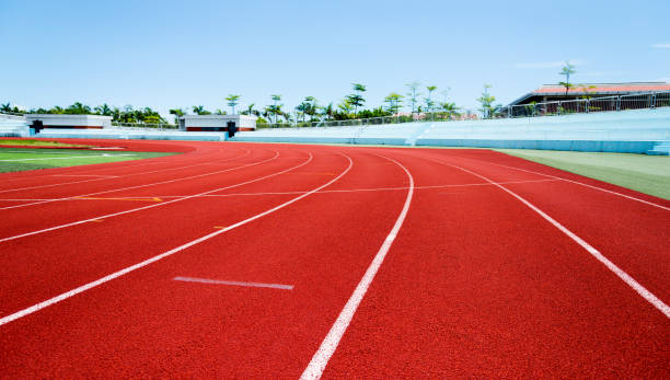 istock Red plastic running track in a playground 1183044888