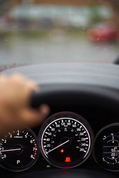 istock Close up of dashboard, speedometer and tachometer with white backlight. modern car interior 1183045596